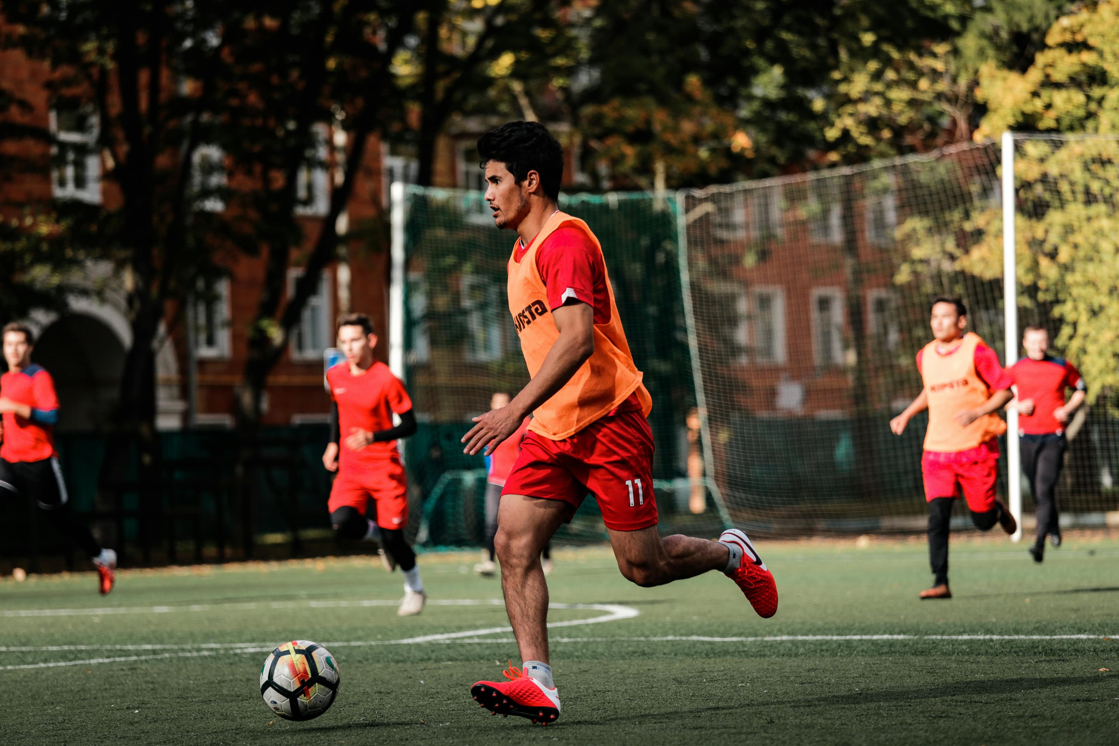 Players in red uniforms training on a field